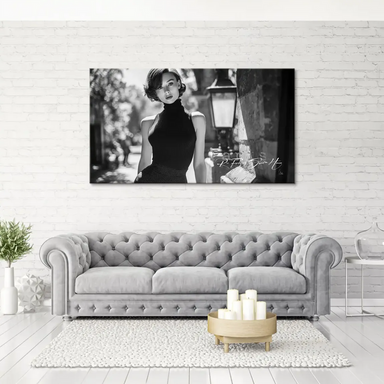 Monochrome fashion portrait evoking Audrey Hepburn in a timeless pose.
