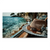 Blue Moments canvas print showing a straw hat and amber sunglasses on a wooden surface with turquoise sea and rocky coastline in the background.