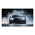 Dark grey Bugatti Chiron emerging from a smoky backdrop with blue-tinted highlights and bright headlights.