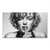 Iconic black-and-white Marilyn Monroe close-up portrait with a shushing gesture on a black canvas
