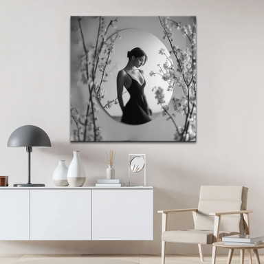 Soft-focused blossoms frame a poised female silhouette on a square canvas wall art.