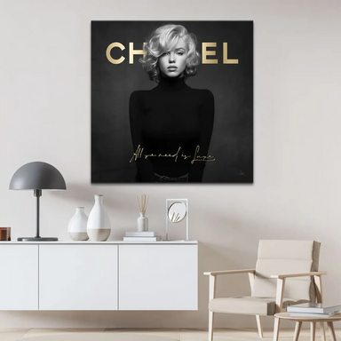 Square-format wall art showing a black-and-white Marilyn portrait with luxe gold lettering