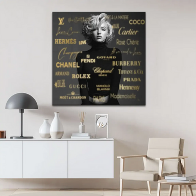 Close-up of Marilyn Monroe with signature blonde curls in monochrome, with luxurious gold brand lettering in the background.