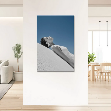Monochrome woman reclining on a diagonal white surface