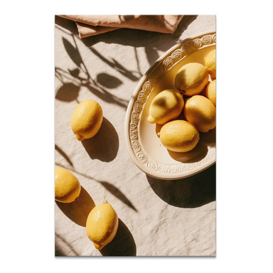 Portrait-oriented canvas print of golden lemons in a cream oval bowl on beige linen