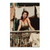 Glamorous dark-haired woman on a rustic balcony in a sunlit European street scene