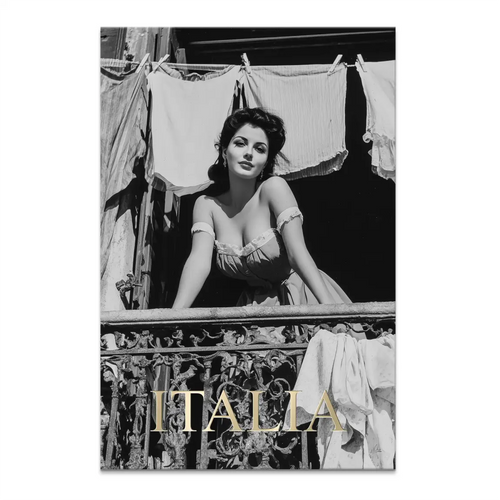Black-and-white vintage portrait of a beautiful Italian woman leaning from a wrought-iron balcony.