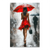 Portrait canvas wall art of a woman walking away in the rain with a red umbrella in a city street
