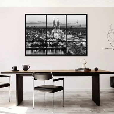 Night scene along the Rhine River with city lights reflecting on the water.