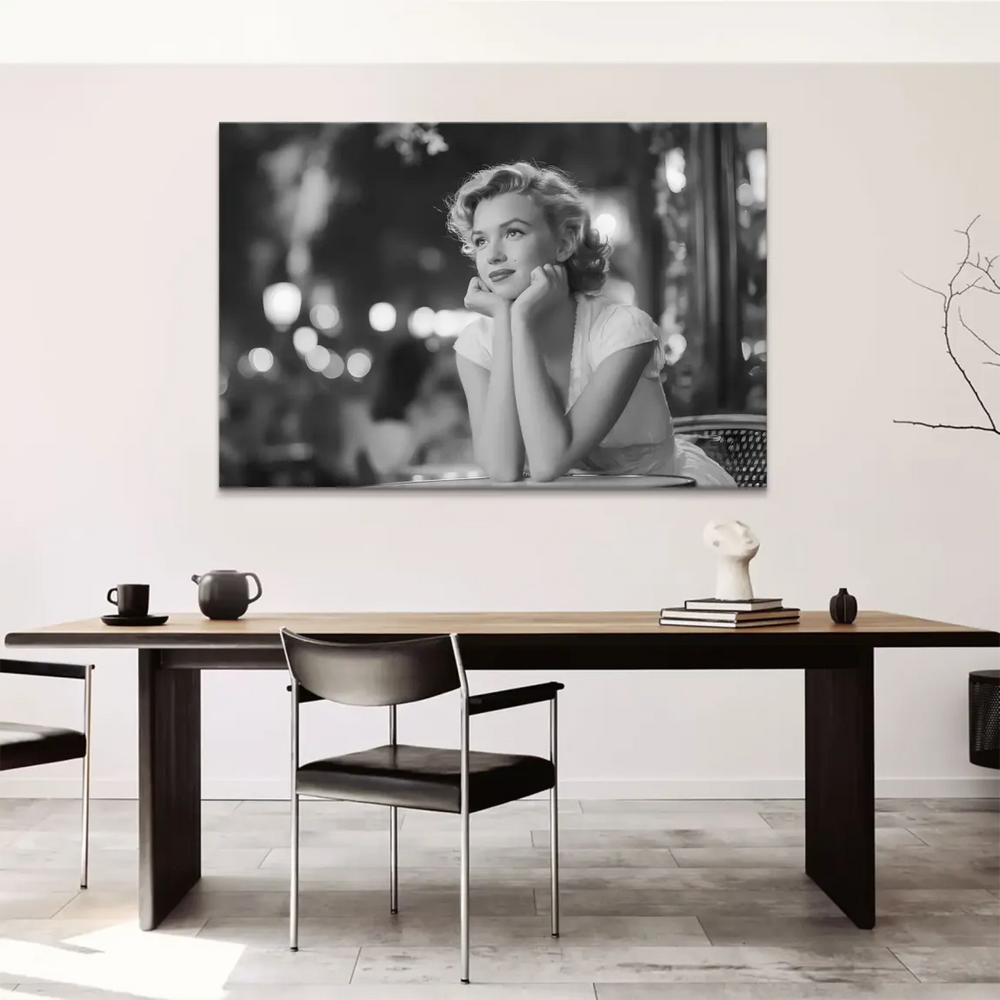 Iconic Hollywood glamour shot of Marilyn Monroe in black and white with a thoughtful pose.