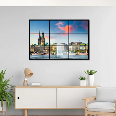 Hamburg skyline at sunset with pink, orange, and blue skies reflecting on Inner Alster Lake