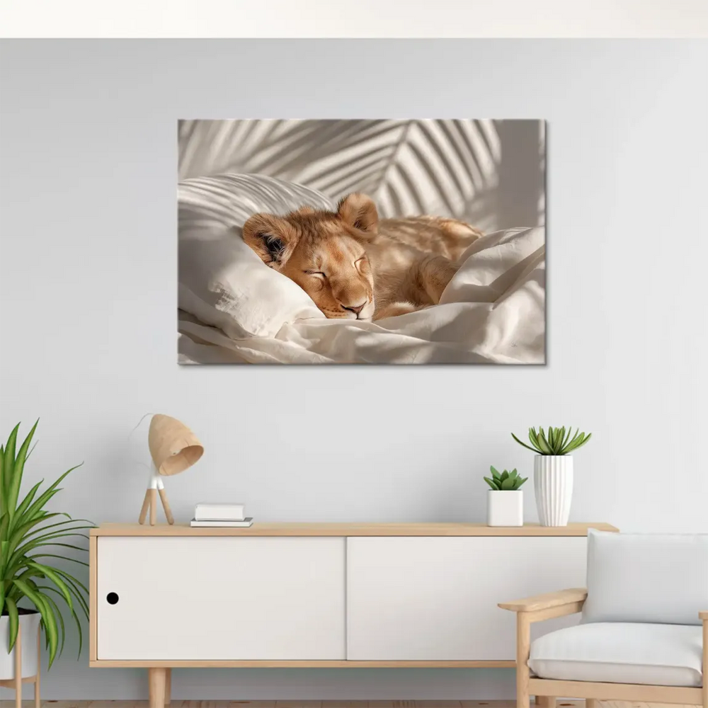 Lion cub resting with palm leaf shadows in the background