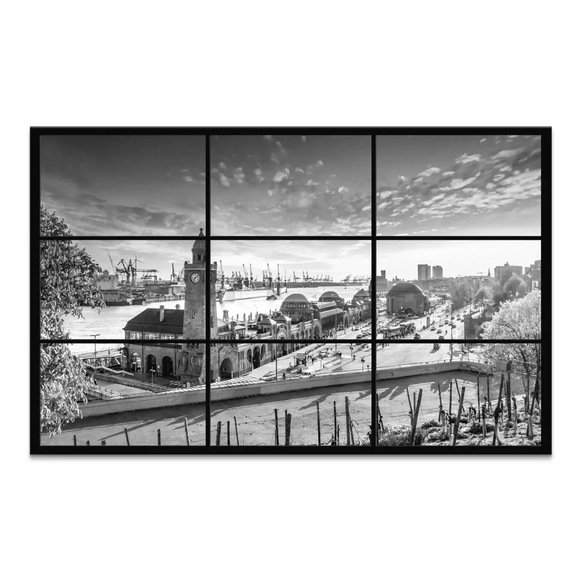 Black and white Hamburg skyline featuring the Landungsbrucken clock tower over the harbor and cranes.