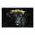 Close-up of a black cow wearing a yellow and pink flower crown against a dark background