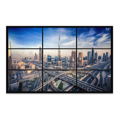 Aerial panoramic view of Dubai's skyline at dusk featuring Burj Khalifa among glassy skyscrapers and glowing highways.