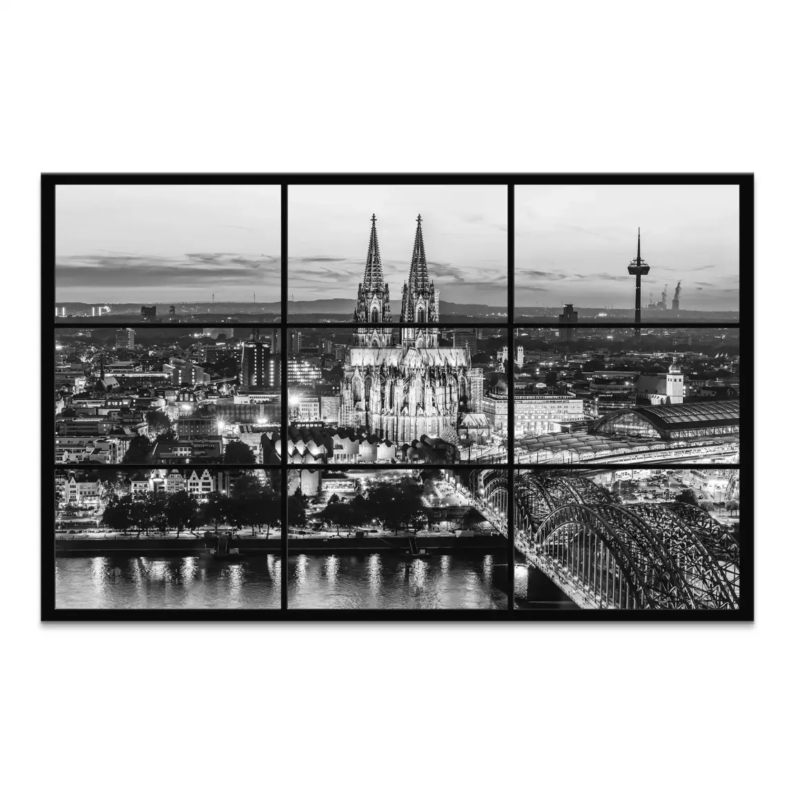 Black-and-white panoramic view of Cologne at night with the illuminated Cologne Cathedral across the river.