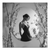 Elegant black and white canvas print showing a solitary woman in a graceful dress, framed by a soft circular void and cherry blossom accents.