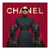 Fashion-forward woman wearing sunglasses and red gloves between two black Doberman dogs on a red background.