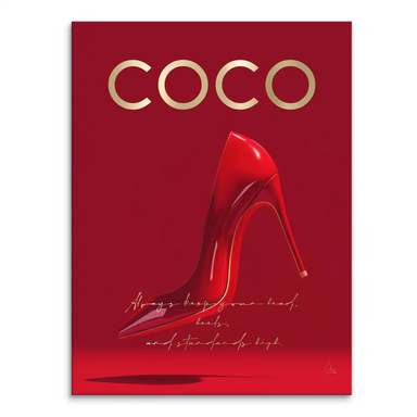 Glossy red high-heeled shoe on a crimson background with gold COCO lettering.