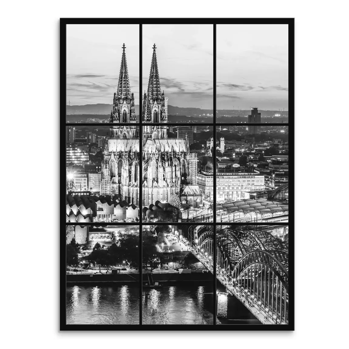 Cologne Cathedral with illuminated spires over the Rhine at dusk in black and white