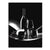 Portrait monochrome canvas wall art featuring a wine bottle, two glasses, an apple, and grapes on a curved platform against a black background.