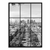 High-angle black-and-white Paris cityscape with a tree-lined avenue receding toward the La Défense skyline.