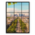 Aerial view of a tree-lined Paris avenue extending toward a modern skyline, viewed as if through a multi-pane window with green foliage at the top.