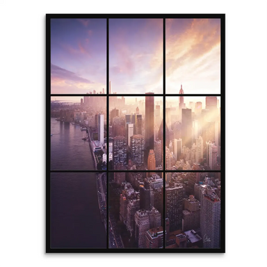 Aerial view of Manhattan skyline at sunrise with tall buildings and a warm gradient sky.
