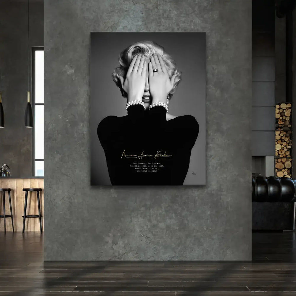 Gold script on the portrait reveals Norma Jeane's birth name and a German quote about imperfection and genius