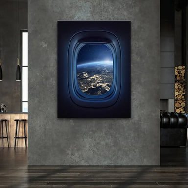 Dark airplane cabin framing a bright sunrise over the curved horizon of Earth