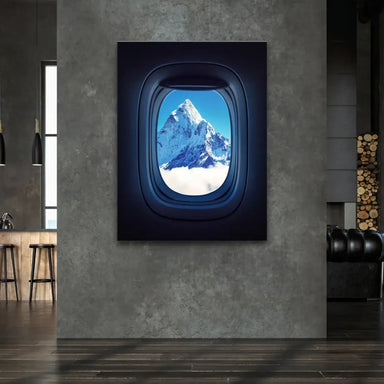 Snow-capped Everest peak framed by airplane window in flight