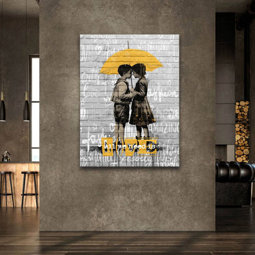 Monochrome kid figures with yellow accent and the words all we need is love in urban art