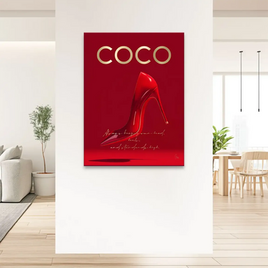 Close-up of a glossy red stiletto with metallic gold COCO lettering.