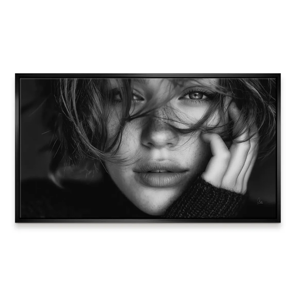 Pensive woman with delicate hand near the jawline in grayscale