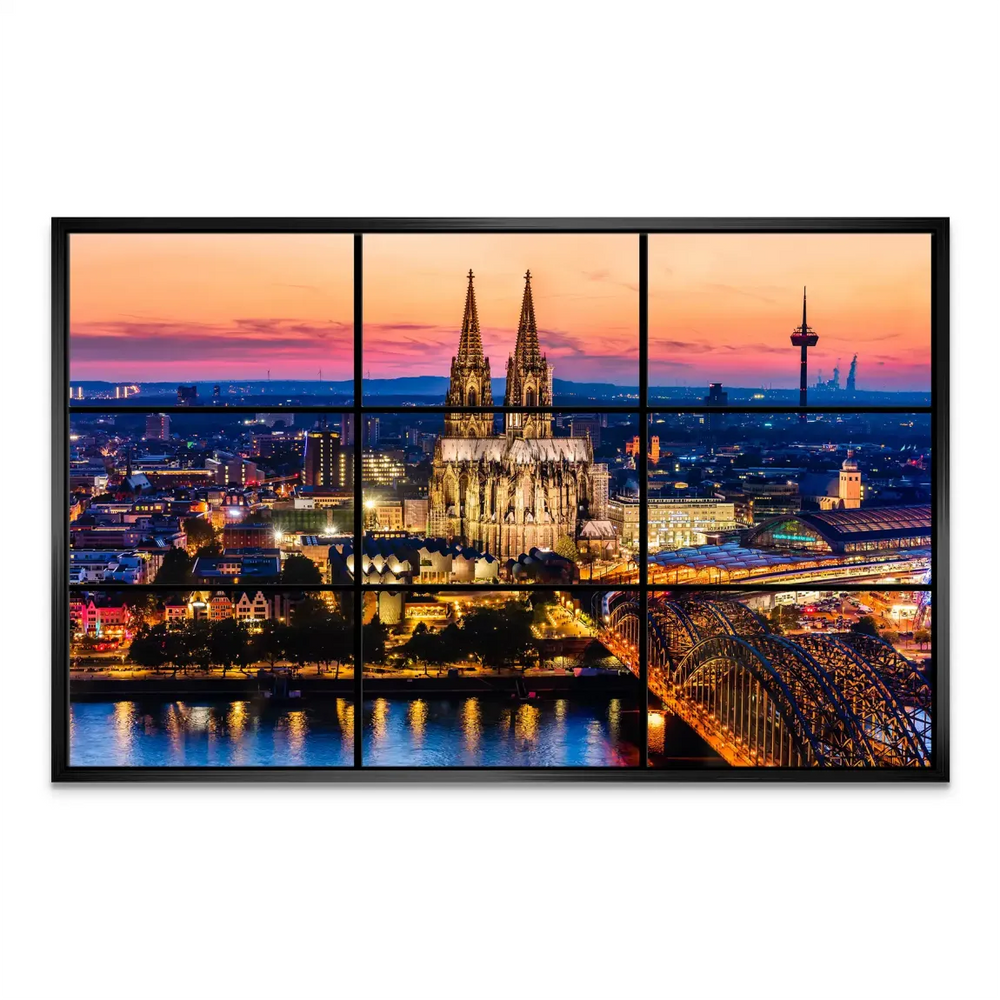 Dusk-lit city center with glowing towers and bridges along the Rhine