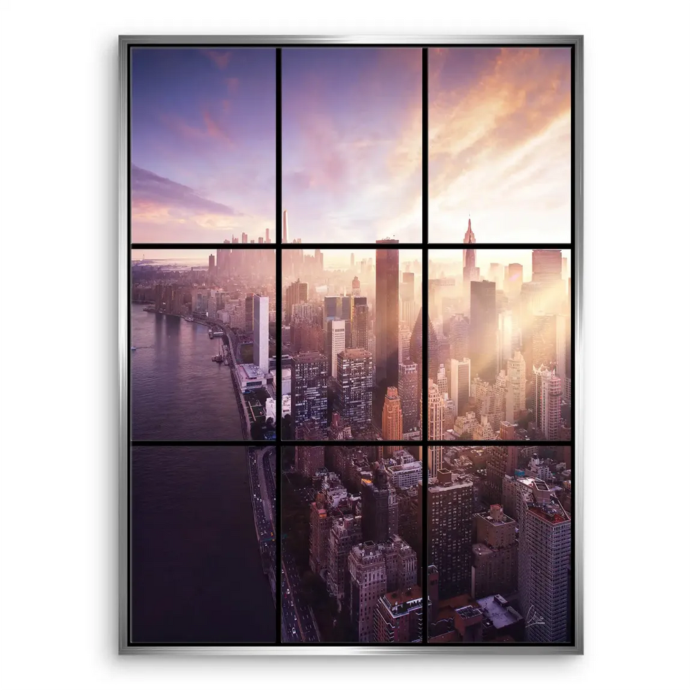 Silhouetted skyscrapers reflecting sunrise colors against a clear blue and orange sky.