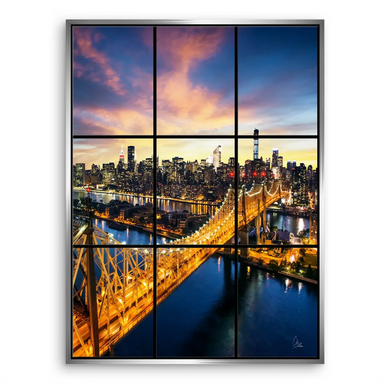 Warm glow of city lights contrasting with a dark blue river under a dramatic sky.