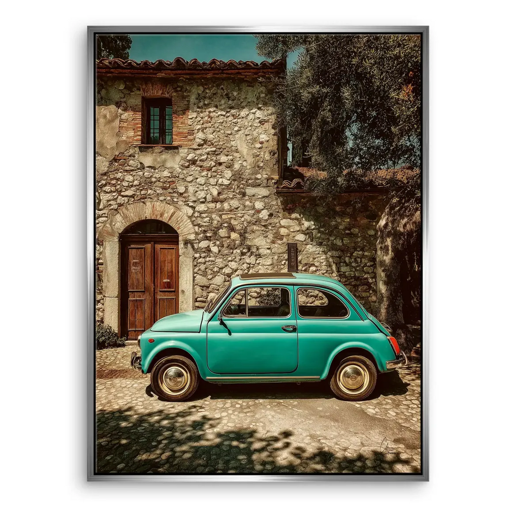 Side view of the teal Fiat 500 with golden light and rustic village backdrop