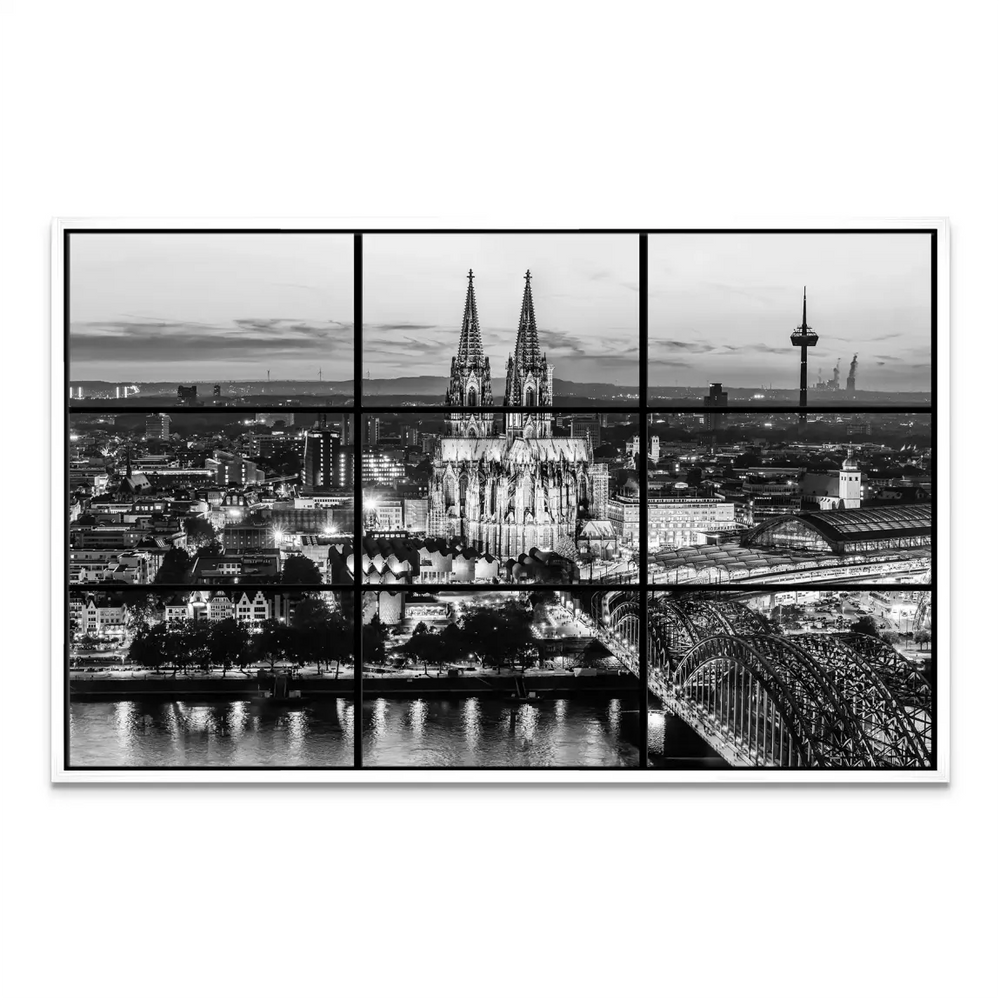 Wide city skyline along the Rhine with historic architecture in monochrome.