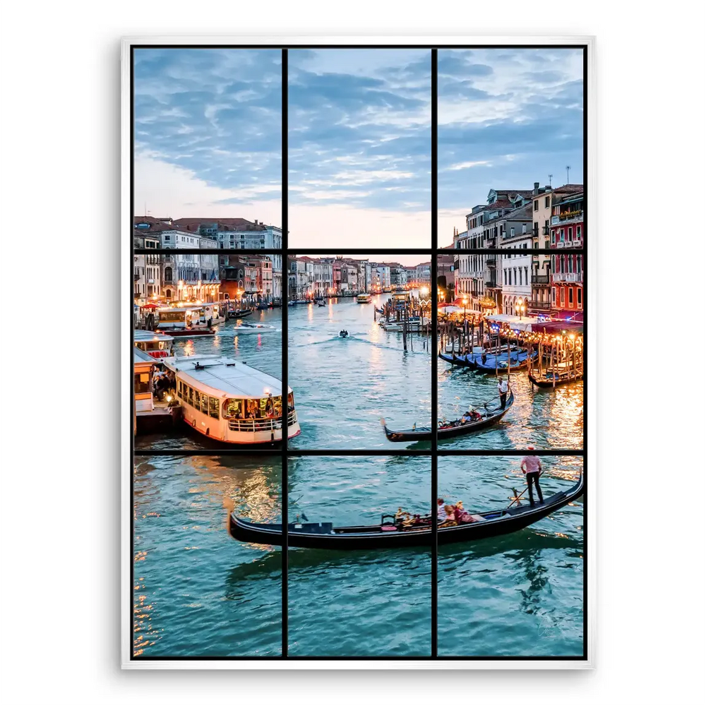 Venice waterway with arched bridges and waterfront buildings at blue hour.